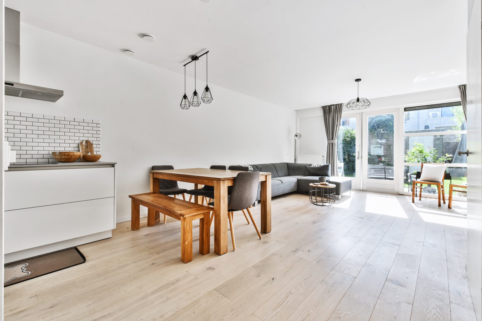An open-plan kitchen and living room filled with daylight